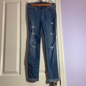 Distressed denim medium wash jean.